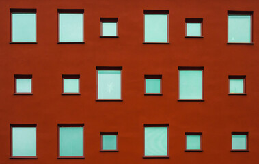 Different size windows on a red facade