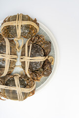 A dish of hairy crabs and river crabs on a white background