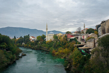 Mostar View on Fall, Clouds, with Islamic Mosques. Medieval Stone Houses, Souvenir Shops, Mountains...