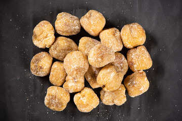 dry Candied dates on black background