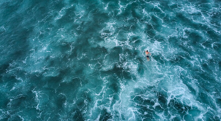 Aerial view of the ocean and surfer girl. Surfing in Midigama. Sri Lanka