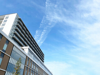 真っ青な大空と新築マンションの背景素材