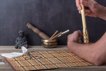 Obraz na płótnie Canvas Chinese copper moxibustion box with smoke on bamboo.