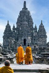 Fototapeta na wymiar Front view of Sewu Temple, with Buddhists wearing orange robes from back. Buddhists in the temple. Unesco, world heritage. Prambanan, Central Java, Yogyakarta, Indonesia. Selective focus.