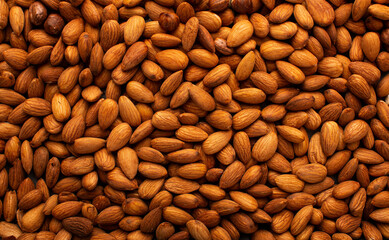Background of big raw peeled almonds situated arbitrarily