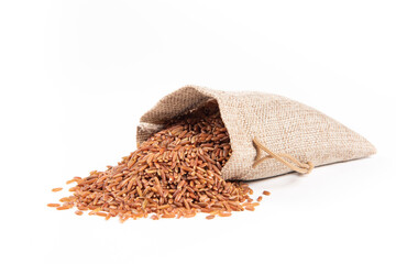 raw red rice in the sack isolated on white background