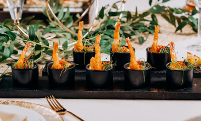 Fried tiger shrimps in breadcrumbs served with mango sauce ready for furshet in restaurant. Seafood, shellfish