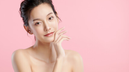 Beautiful young asian woman with clean fresh skin on pink background, Face care, Facial treatment, Cosmetology, beauty and spa, Asian women portrait.