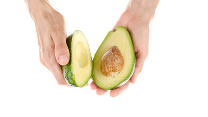 Female hands hold avocado. Twist the avocado with hand to open it. Healthy Vegan Food Concept