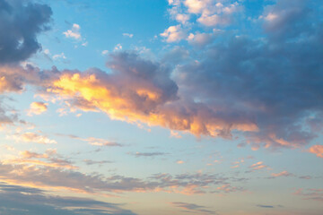 Naklejka na ściany i meble Beautiful fluffy clouds painted in bright painterly colors at sunset. Multicolor background or wallpaper