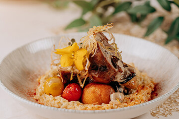 Meat roll with prunes is served on a pillow of vegetables and rice in restaurant
