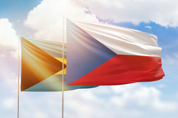Sunny blue sky and flags of czechia and bahamas