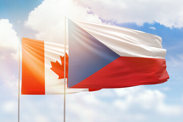 Sunny blue sky and flags of czechia and canada