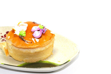 A chiffon cake with orange jam jelly on a white background baked fresh and fresh in a bakery that...