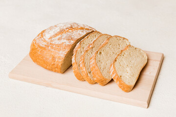 Assortment of freshly sliced baked bread with napkin on rustic table top view. Healthy unleavened bread. French bread slice