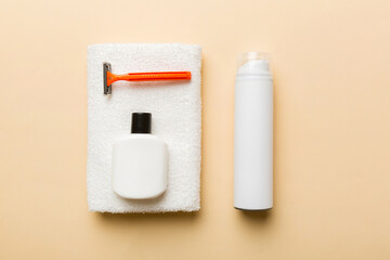 shaving man set. shaving machine, towel, lotion and shaving foam on colored background. Men bath Accessories top view