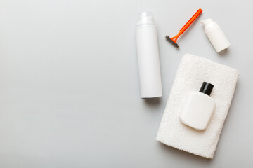 shaving man set. shaving machine, towel, lotion and shaving foam on colored background. Men bath Accessories top view