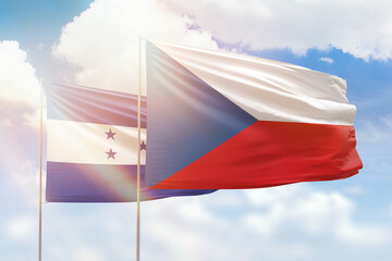 Sunny blue sky and flags of czechia and honduras