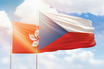Sunny blue sky and flags of czechia and hong kong