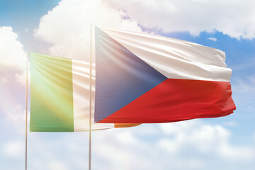 Sunny blue sky and flags of czechia and ireland