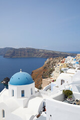 The focus view of the blue-domed church in Santorini.