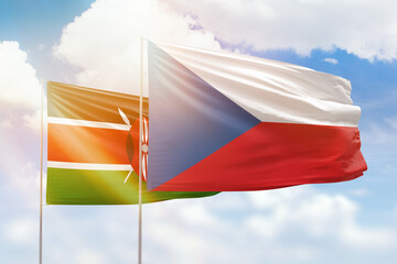 Sunny blue sky and flags of czechia and kenya