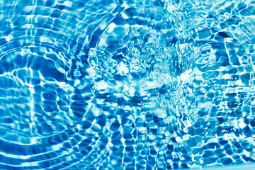 Abstract blue water background with circles. Ripples on water surface.