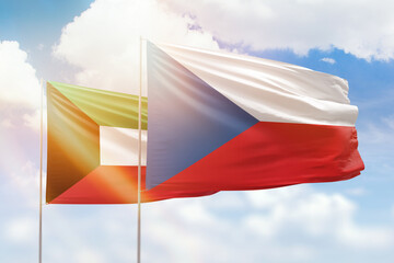 Sunny blue sky and flags of czechia and kuwait