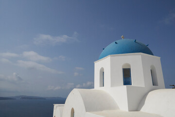 The focus view of the blue-domed church in Santorini.