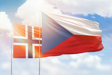 Sunny blue sky and flags of czechia and norway