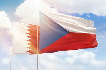 Sunny blue sky and flags of czechia and qatar