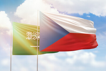 Sunny blue sky and flags of czechia and saudi arabia