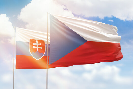 Sunny blue sky and flags of czechia and slovakia