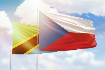 Sunny blue sky and flags of czechia and tanzania