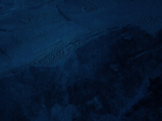 Dark rough cement wall background for graphic design or wallpaper.