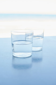 Two half-full glasses of fresh water ready to drink on a summer day