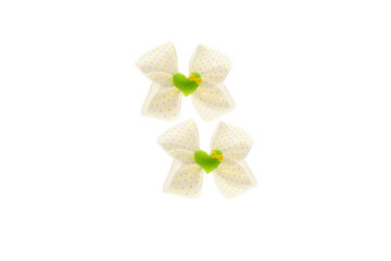 White with yellow dots satin bow for hair for girl, woman isolated on white background. Scrunchie hair clip accessory for girls and women. Close up