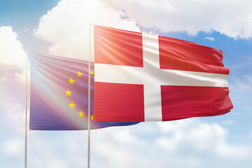Sunny blue sky and flags of denmark and european union