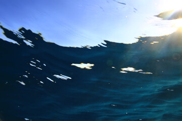 ocean underwater rays of light background, under blue water sunlight