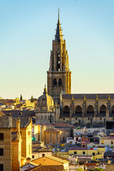 Fototapeta na wymiar Tower of the cathedral of Toledo rising above the buildings of the city.