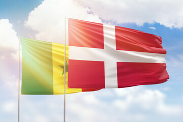 Sunny blue sky and flags of denmark and senegal