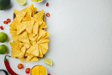 Nachos corn chips with traditional dip sauce , on white background, top view or flat lay with copy...