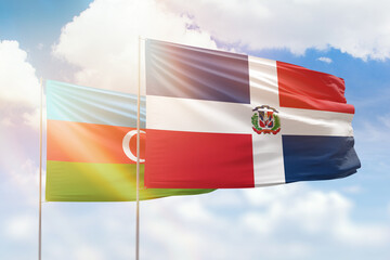 Sunny blue sky and flags of dominican republic and azerbaijan