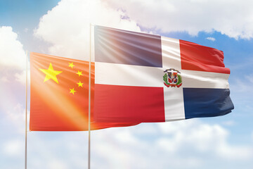 Sunny blue sky and flags of dominican republic and china