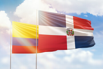 Sunny blue sky and flags of dominican republic and colombia