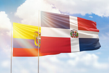 Sunny blue sky and flags of dominican republic and ecuador