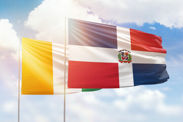 Sunny blue sky and flags of dominican republic and ivory coast