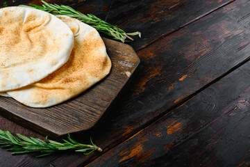 Pita bread on kitchen set, on old dark  wooden table background, with copy space for text
