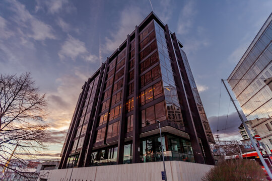 Glass facades of the building of the old age insurance inter professional fund at dusk. Geneva, Switzerland, 2022.