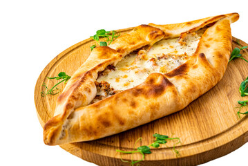 pide with meat and cheese on wooden plate isolated on white background